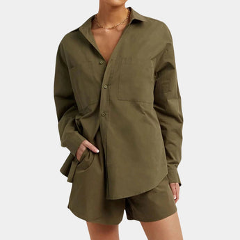 
An oversized silk shirt in a light yellow color, showcasing a luxury soft touch fabric with a relaxed fit. The shirt features a classic collar, long sleeves, and falls gracefully over the waist. The model demonstrates the garment with attention to shoulder and arm details, emphasizing the shirt's elegant drape and soft texture.