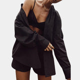 Light yellow women's oversized silk shirt with long sleeves and a soft touch fabric, shown in a relaxed fit on a model. The shirt has a luxury feel and features a classic collar and button-down front. It is paired with black accessories and is displayed in an XL size.