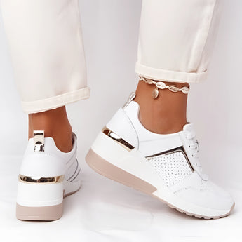 Lightweight beige women's low-top fashion sneakers displayed on a person's feet, showcasing their chic and breathable design.