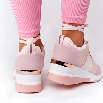 Lightweight beige women's low-top fashion sneakers with a chic and breathable design, worn on a person's foot against a neutral background.