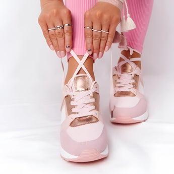 A pair of lightweight beige women's low-top fashion sneakers being worn, showcasing their chic and breathable design.