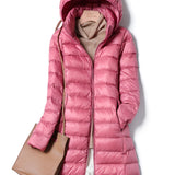 Woman wearing a light pink 4XL insulated quilted jacket with water-resistant material, featuring a collar and long sleeves.