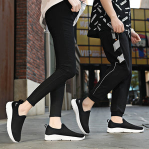 
A pair of lightweight breathable black mesh slip-on sport sneakers designed for unisex wear, showcasing a sleek and stylish design suitable for athletic and casual use. The sneakers feature a durable mesh upper for enhanced airflow and comfort.
