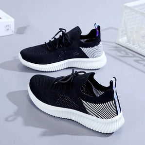 Lightweight mesh running shoes in black and white stripes with a non-slip sole, designed for sportswear and walking.