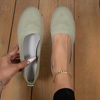Lightweight pink ballet flats featuring breathable mesh design for comfortable summer walking, shown on a person's feet.