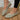 Light green lightweight ballet flats made with breathable mesh material, shown on a person's foot for summer walking.