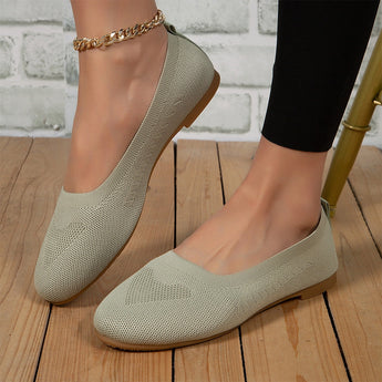 Light green lightweight ballet flats made with breathable mesh material, shown on a person's foot for summer walking.