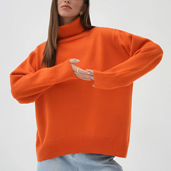Orange chunky knit turtleneck sweater with long sleeves, suitable for cozy winter fashion, displayed on a person wearing jeans.