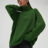 Lime green chunky knit turtleneck sweater in dark green, showcasing a cozy and fashionable winter design. The image highlights the sweater's long sleeves, high neck collar, and textured knit pattern, providing a comfortable fit.