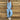 Women's linen jumpsuit in blue sky color, featuring a casual boho chic design, short sleeves, and a comfortable fit suitable for summer wear.