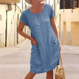 Linen knee-length tunic dress in azure blue, featuring a flattering round neckline, short sleeves, and a relaxed fit. Perfect for casual summer outings or travel.