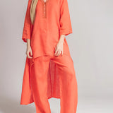 Women's pink linen loungewear set featuring a tunic with long sleeves and matching pants, designed for summer maternity comfort.