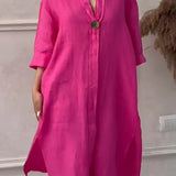 Pink linen midi dress with button-down front, featuring three-quarter sleeves and a neutral color palette.