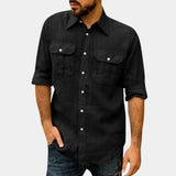A man wearing a relaxed-fit black linen shirt paired with jeans, showcasing a casual, lightweight summer style.