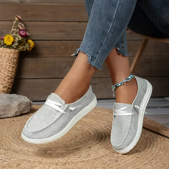 Gray linen women's sneakers in size 43, eco-friendly design with breathable material, shown on a person wearing casual attire.