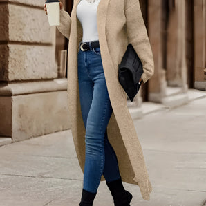Long beige oversized wool coat for women with a cachi variant in size 2XL, featuring full-length sleeves and a tailored look, ideal for winter fashion. The model is standing, showcasing the coat's structure and fit.