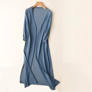 Elegant long sleeve formal blue gown with a draped crossover design, featuring a fitted waist and a flowing skirt in an electric blue color, suitable for formal occasions.