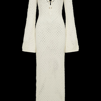 Long sleeve white crochet midi dress in a bohemian style, suitable as a beach cover-up, featuring intricate crochet patterns and a relaxed, elegant fit.