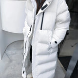 Long white oversized hooded puffer coat with thermal insulation, featuring a sleek design and button details, perfect for winter fashion.