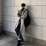 A gray, double-breasted winter coat for men in size 3XL, featuring a stylish urban design with a high collar and long sleeves.