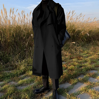 A stylish long white men's double-breasted winter coat worn outdoors, showcasing urban fashion with a formal design.