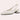 Beige low-heel flats for women with a minimalist design, crafted from leather for comfort, shown being worn on a human leg.