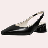 Low-heel black flats for women made of minimalist leather, showcasing a simple and elegant design.