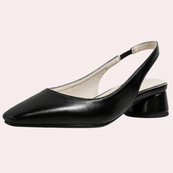 Low-heel black flats for women made of minimalist leather, showcasing a simple and elegant design.