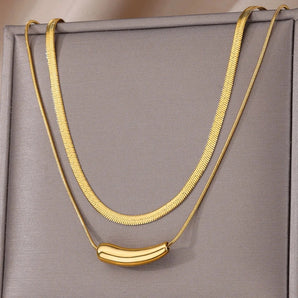 Luxurious double layer gold necklace featuring a minimalist and versatile choker design.
