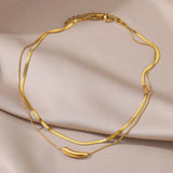 Luxurious double layer gold necklace featuring minimalist design, shown as a versatile choker made of metal, highlighting its natural material and fashionable appeal.