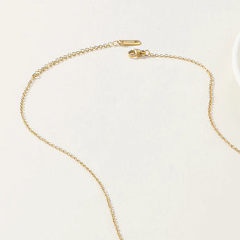 Luxurious gold circle pendant necklace with blue beads, elegant YA-CHAN Jewelry accessory on display.