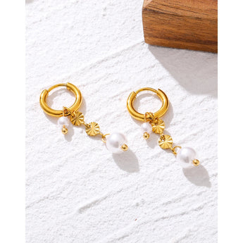 Luxurious gold floral hoop earrings with baroque pearl drops featuring intricate metalwork and natural gemstone accents.