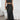 Luxurious silk satin skirt set featuring a high-waist maxi skirt and a backless halter top in Nero color, size XL. The set is elegantly designed with a focus on the waist and neck, offering a sleek and sophisticated look.