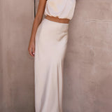 Luxurious beige silk satin skirt set featuring a high-waist maxi skirt paired with a backless halter top, designed for a size XL fit.