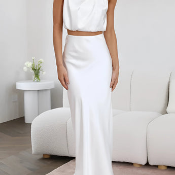 Luxurious white silk satin skirt set featuring a high-waist maxi skirt and a backless halter top, showcasing an elegant and comfortable fit.