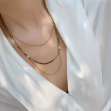 Luxury 18K Gold Plated Snake Chain Necklace displayed on a women's neck, showcasing its sleek and elegant design.