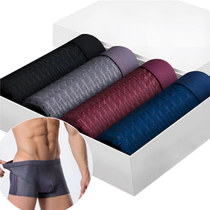 A pair of men's luxury bamboo boxer briefs in a violet color, displayed on a studio couch, showcasing their breathable and moisture-wicking fabric for ultimate comfort.