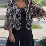 Luxury beaded poncho featuring a black and silver design, draped elegantly over the shoulders and neck, complementing an evening dress.