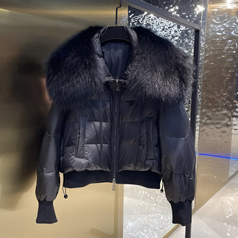 Luxury black puffer jacket with a prominent fur collar, featuring long sleeves and a sleek designer fashion look.