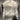 
A luxury black puffer jacket with a fur collar displayed on a mannequin, showcasing designer winter fashion with long sleeves.