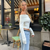 A woman standing and modeling a stylish streetwear outfit featuring a luxury black hair bow. She is wearing a fashionable blazer and has her hair styled up to highlight the elegant bow. The image showcases the bow as a chic accessory, complementing her contemporary fashion look.