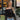 Luxury black hair bow styled as a trendy streetwear accessory for women, complementing a fashionable outfit with a blazer, highlighting cool and stylish elegance.