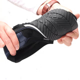 Luxury black leather men's formal shoes featuring a designer checkered pattern with a focus on comfort and style, depicted on a model's feet and hands showcasing the details.