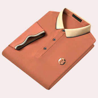 Luxury black polo shirt with a contrasting orange collar and embroidered logo, designed in a 2XL size, featuring short sleeves and button details.