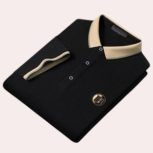 Luxury black polo shirt in size 2XL featuring a contrast collar and logo embroidery. The shirt has short sleeves, a buttoned placket, and subtle design elements that give it a sophisticated look.