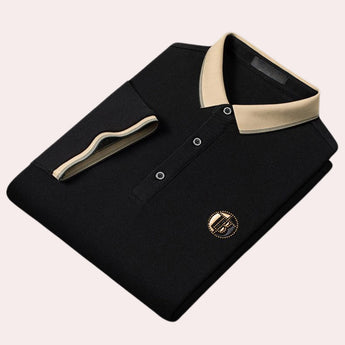 Luxury black polo shirt in size 2XL featuring a contrast collar and logo embroidery. The shirt has short sleeves, a buttoned placket, and subtle design elements that give it a sophisticated look.