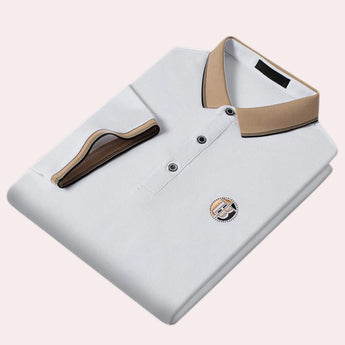 Luxury black polo shirt featuring a contrasting white collar, embroidered logo on the chest, and a short sleeve design, available in size 2XL.