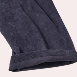 Luxurious black velvet wide-leg jumpsuit featuring a soft and stylish design with convenient pockets, perfect for an elegant yet comfortable look.