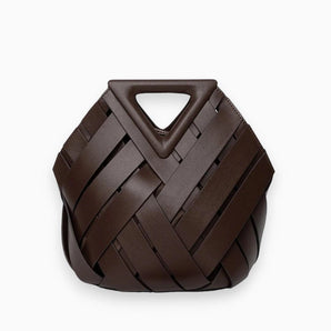Luxury brown leather woven bag featuring a unique triangular handle, displayed on a wooden surface. The bag's intricate woven pattern and sleek design highlight its fashion accessory appeal.
