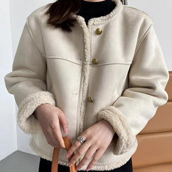 Luxury brown suede jacket with shearling collar, featuring long sleeves and stylish design, modeled over a white dress shirt.